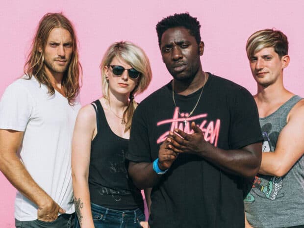Bloc Party band members standing against a pink wall, HD Desktop Wallpaper