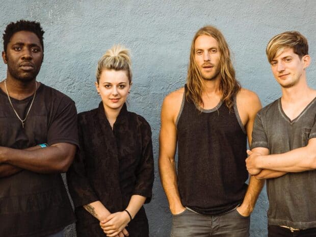 The Bloc Party band stands against a blue wall looking at the camera, HD Desktop Wallpaper