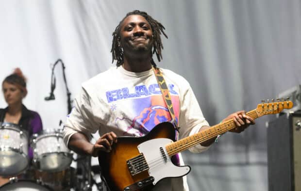 A Bloc Party band member is playing the electric guitar during a live performance, HD Desktop Wallpaper