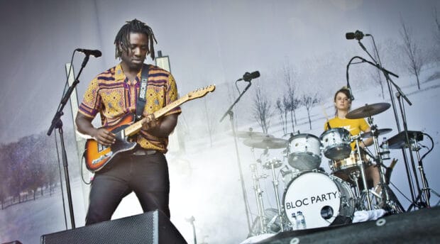 A guitarist and drummer from Bloc Party band playing music during a concert, HD Desktop Wallpaper