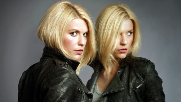 A blonde woman in a black leather jacket looks at her reflection with a serious expression in Homeland Wallpapers, HD Desktop Wallpaper