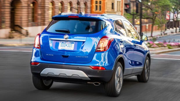 A blue Buick Encore is driving through an urban area with buildings in the background, 4K Desktop Wallpaper