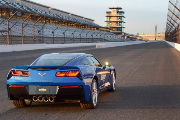 A blue Corvette car is parked on the race track of Indianapolis Motor Speedway at sunset, 2K Desktop Wallpaper