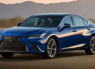 A blue Lexus ES is parked on a desert road with mountains in the background at sunset, HD Desktop Wallpaper