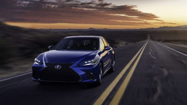 A blue Lexus ES is driving on a long desert road during sunset with mountains in the background, 4K Desktop Wallpaper