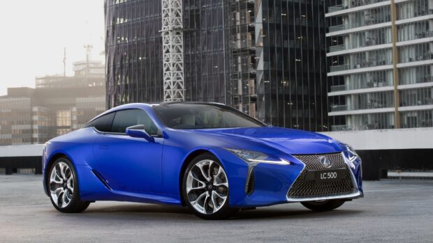 A blue Lexus LC 500 is parked in front of urban skyscrapers during the day, 4K Desktop Wallpaper