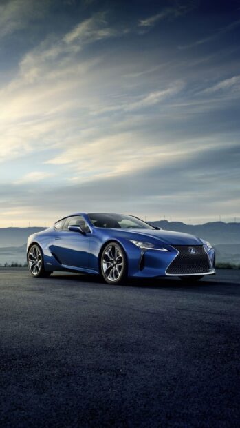 A blue Lexus LC is parked on an open road with a cloudy sky and distant mountains in the background, HD Phone Wallpaper