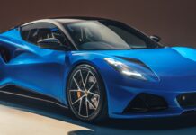 A sleek blue Lotus Emira sports car showcased in a modern setting with detailed features, 2K Desktop Wallpaper