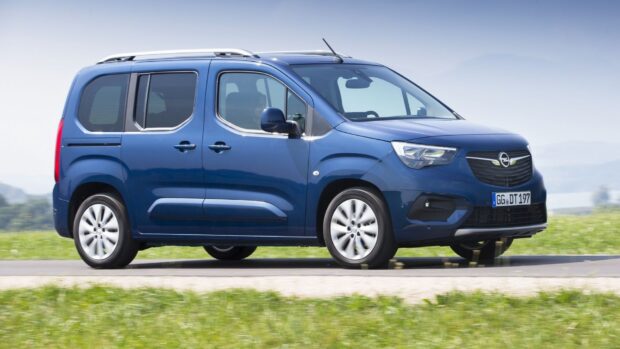 The Opel Combo is captured in a scenic outdoor setting with grass and clear sky, HD Desktop Wallpaper