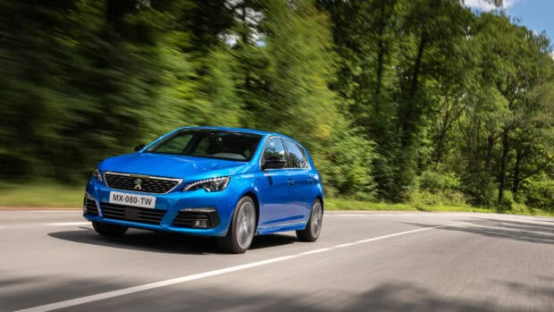 A blue Peugeot 308 is driving quickly on a road surrounded by green trees, 4K Desktop Wallpaper