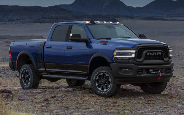 A powerful Ram truck is shown off road with mountains in the background, HD Desktop Wallpaper