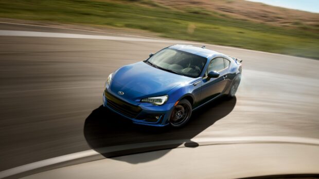A blue Subaru Brz car is drifting on a curved racetrack during the day, 4K Desktop Wallpaper