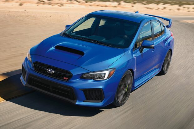 A blue Subaru WRX is driving fast on a desert road with a driver wearing a helmet inside, HD Desktop Wallpaper
