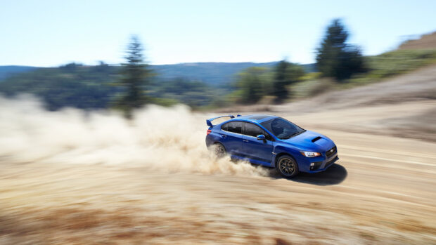 Blue Subaru Wrx speeding on dirt road in open landscape, HD Desktop Wallpaper