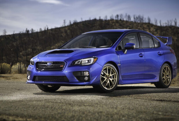 Blue Subaru WRX with golden rims parked under a cloudy sky, HD Desktop Wallpaper