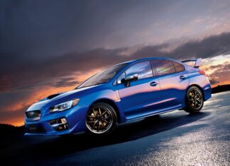 A blue Subaru Wrx is parked on wet pavement under a colorful sunset sky, HD Desktop Wallpaper