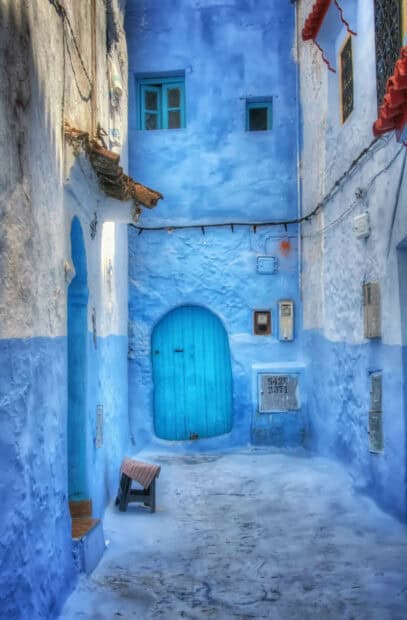 A narrow street features vibrant blue walls and a matching door in Morocco Wallpapers, HD Mobile Wallpaper