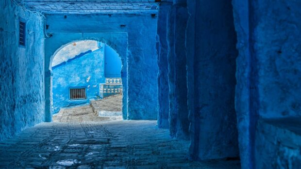 A blue alleyway in Morocco showcases detailed architecture and cobblestone paths, HD Desktop Wallpaper