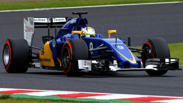 A blue and yellow race car speeds on the race track during a professional race event, HD Desktop Wallpaper