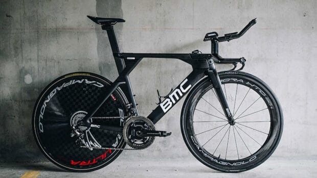 A sleek Bmc Bikes racing bike stands against a concrete wall in this image, HD Desktop Wallpaper