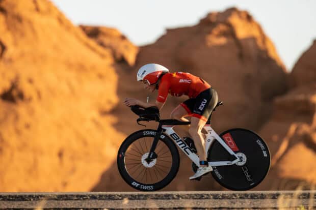 A cyclist riding a Bmc bike in a desert landscape during sunset, 2K Desktop Wallpaper