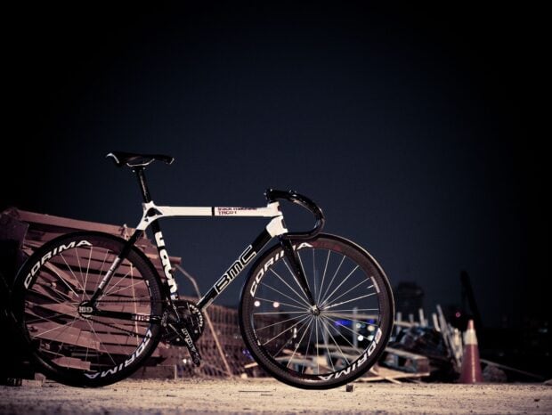 The Bmc Bikes features a sleek black and white design with Corima wheels under night lighting, HD Desktop Wallpaper