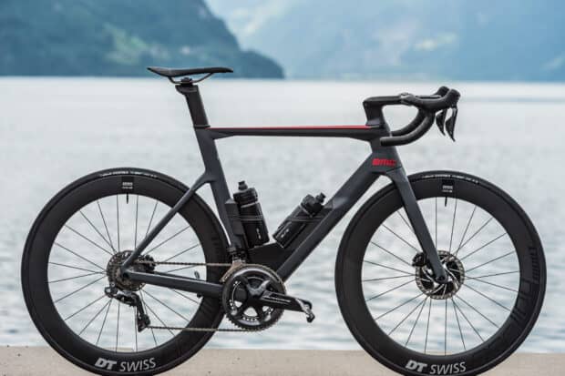 A sleek black Bmc bikes are parked near a lake with mountains in the background, HD Desktop Wallpaper