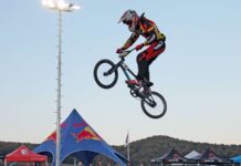 A BMX sports rider is captured mid air during a competition, HD Desktop Wallpaper