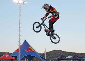 A BMX sports rider is captured mid air during a competition, HD Desktop Wallpaper
