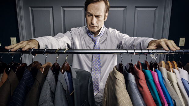 Bob Odenkirk is looking at a variety of suits on a clothing rack, HD Desktop Wallpaper