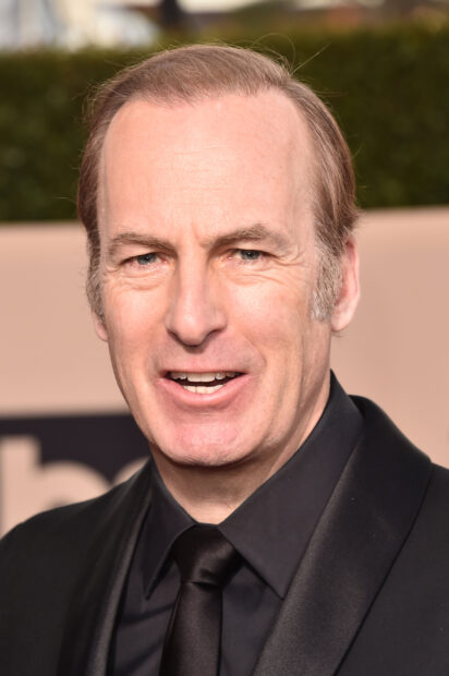 Bob Odenkirk is wearing a black suit and smiling in the photo, 2K Mobile Wallpaper