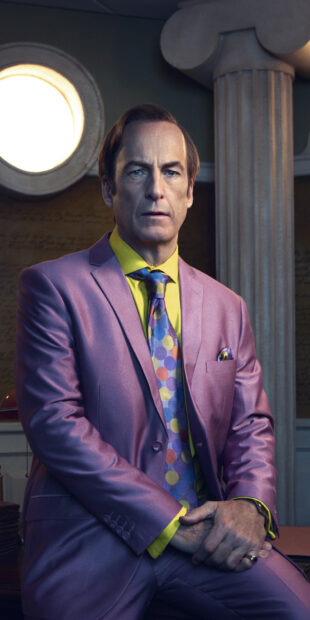 Bob Odenkirk is seated wearing a colorful purple suit with a patterned tie, HD Mobile Wallpaper