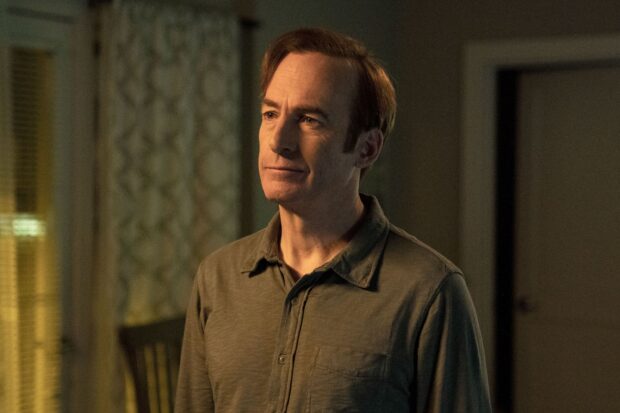 Bob Odenkirk stands with a calm expression in a dimly lit room, 2K Desktop Wallpaper