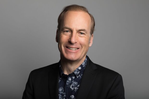 Bob Odenkirk wallpapers shows a man smiling in a dark suit with a floral shirt, HD Desktop Wallpaper