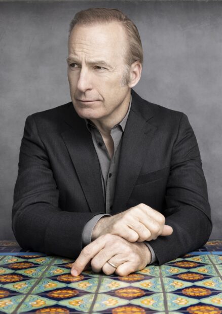 Bob Odenkirk is sitting and looking to the side in a thoughtful pose, 2K Phone Wallpaper