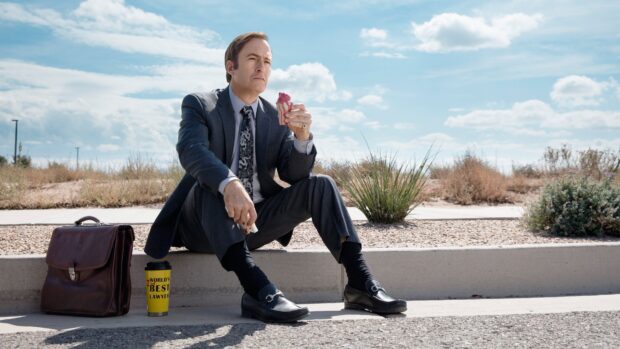 Bob Odenkirk sitting on a sidewalk eating ice cream with a briefcase and coffee cup nearby, 4K Desktop Wallpaper