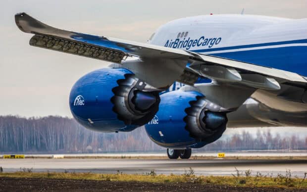 A Boeing 747 cargo jet with blue engines preparing for takeoff on the runway, 2K Desktop Wallpaper
