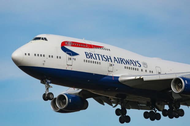 A Boeing 747 in British Airways livery is preparing to land with extended landing gears against a clear sky, HD Desktop Wallpaper