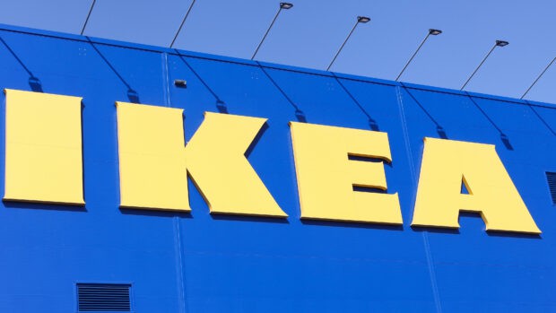 The bold yellow Ikea letters are displayed on a bright blue wall with mounted lights, 4K Desktop Wallpaper