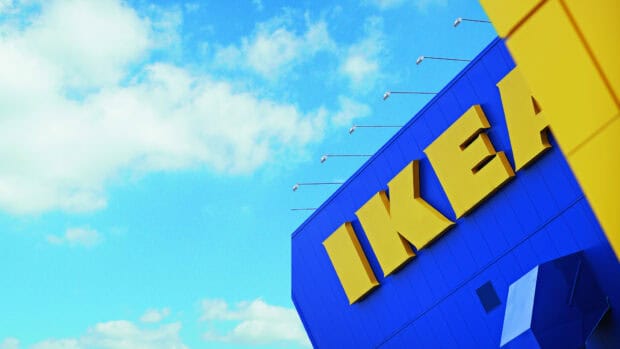 The Ikea logo is displayed on a bright blue building with clouds in the sky, HD Desktop Wallpaper
