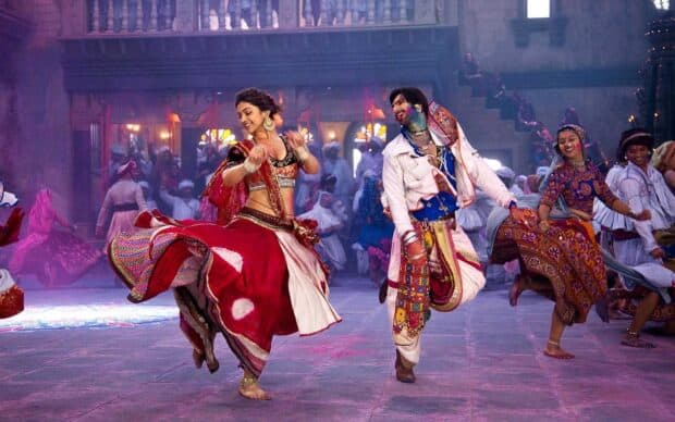 A vibrant Bollywood dance scene with colorful traditional attire and joyous expressions in a festive setting, HD Desktop Wallpaper