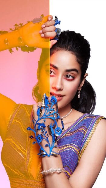 A Bollywood star poses with a decorative blue floral hand accessory and bright makeup, 4K Mobile Wallpaper