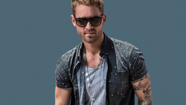 Brett Young Wallpapers shows a man wearing sunglasses and tattoos with a blue background, HD Desktop Wallpaper