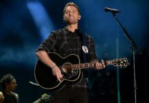 Brett Young performing live on stage playing guitar during a concert, HD Desktop Wallpaper