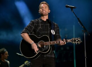 Brett Young performing live on stage playing guitar during a concert, HD Desktop Wallpaper
