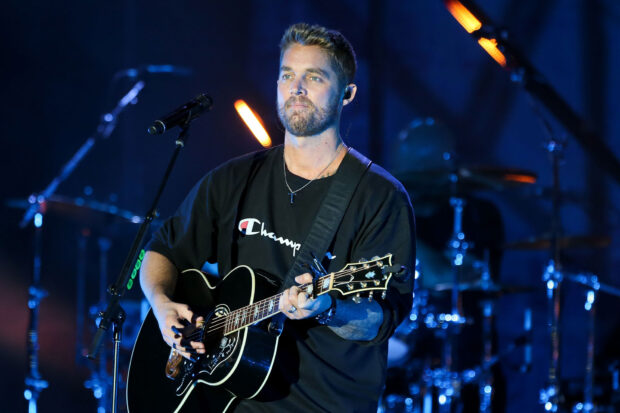 Brett Young is playing guitar and singing during a live performance, HD Desktop Wallpaper