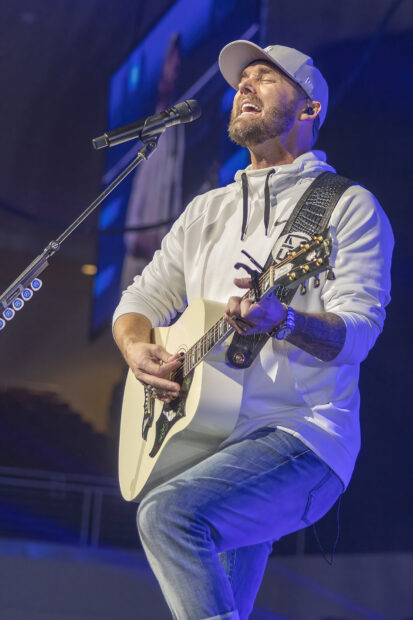 Brett Young passionately singing and playing guitar during a live concert, HD Mobile Wallpaper