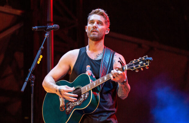 A male musician is playing guitar during a live performance featuring Brett Young wallpapers, HD Desktop Wallpaper