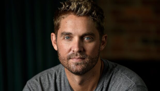 A close up portrait of Brett Young showing his thoughtful expression and blue eyes, 2K Desktop Wallpaper