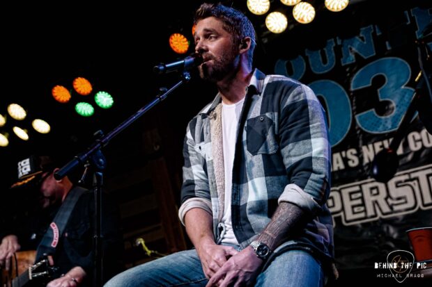 Brett Young sings passionately during a live performance with a guitar player in the background, HD Desktop Wallpaper